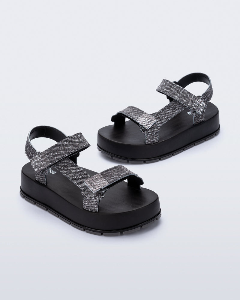 Angled view of a pair of black jean Flowing Denim platforms