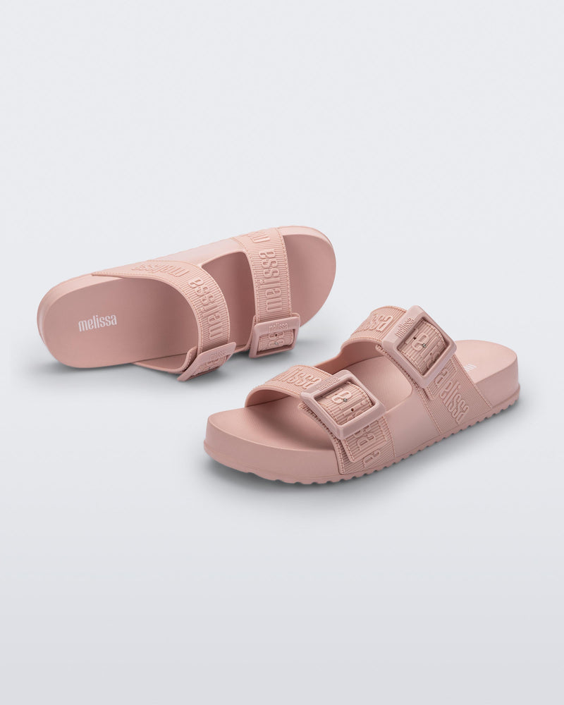 Top and angled view of a pair of pink Cozy M Love adult slides