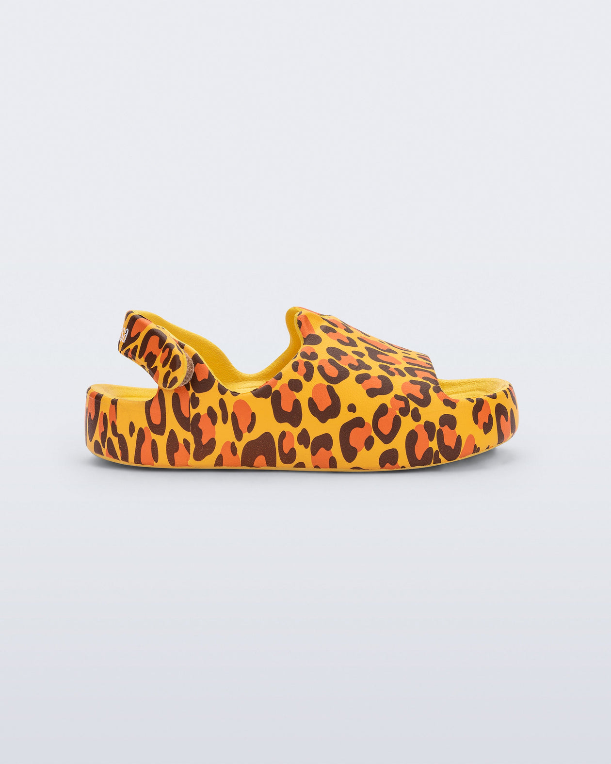 Side view of a yellow Free Cute baby sandal with leopard print