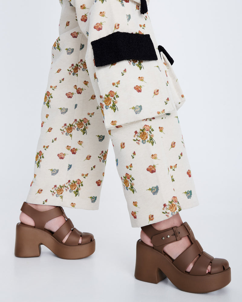 Model's legs in a pair of brown Lulu platform sandals