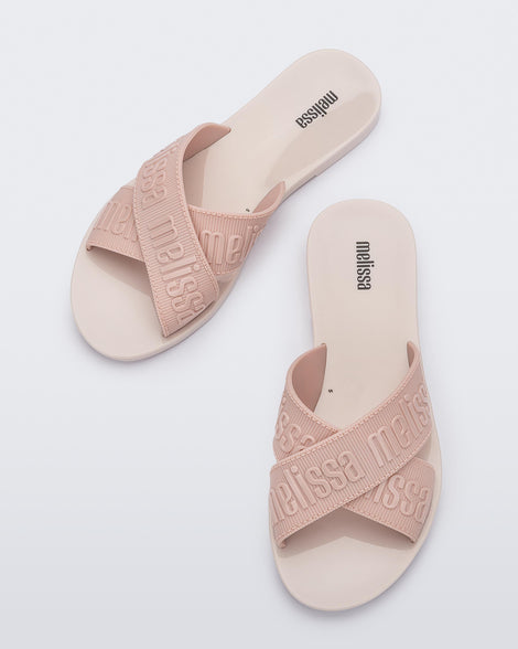 Top view of a pair of beige M Lover adult slides