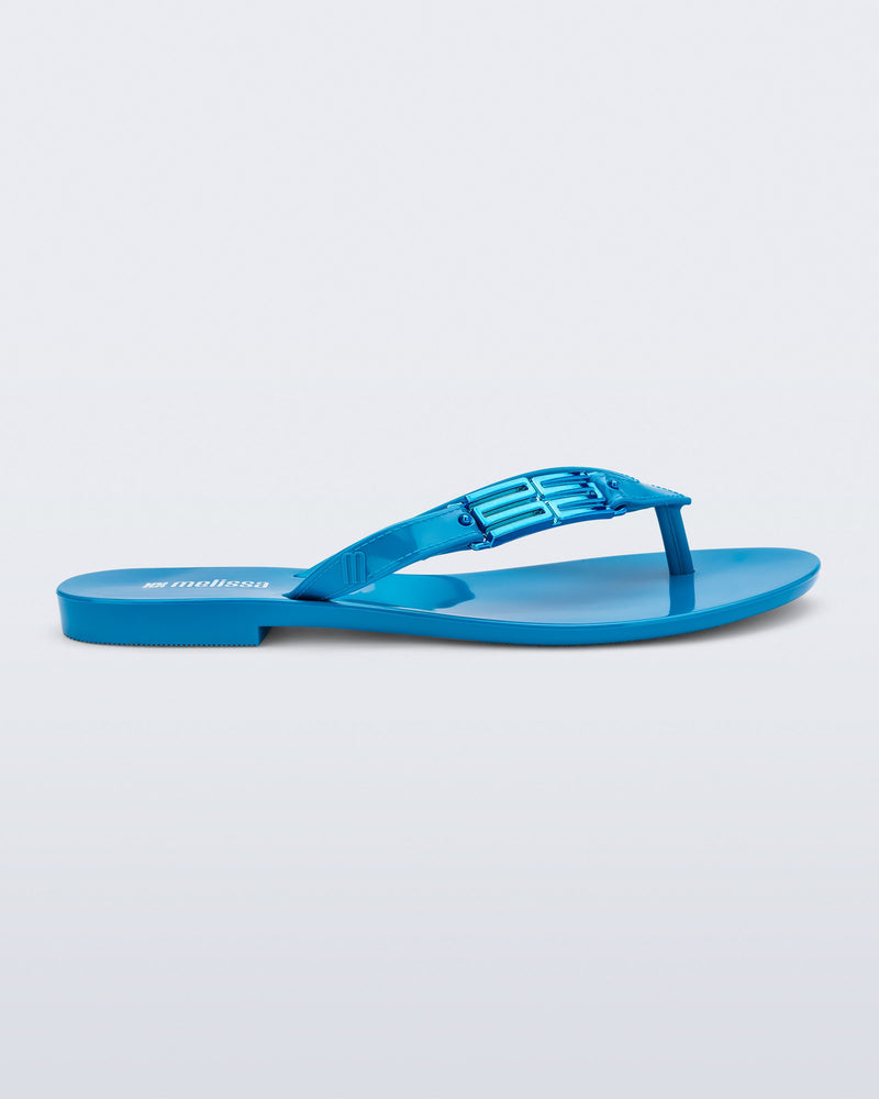 Side view of a blue Harmonic M Chic flip flop