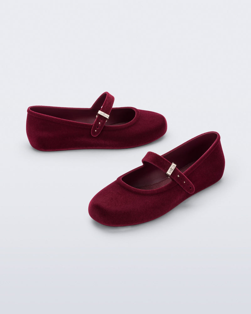 Side and angled view of a pair of red Soft Ballerina Velvet II flats