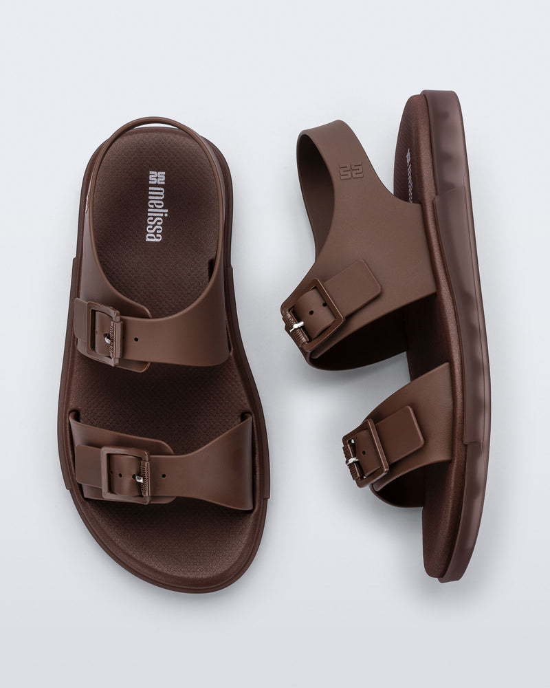 Side and top view of a pair of brown Wave Sandals with two straps with buckles and a back strap