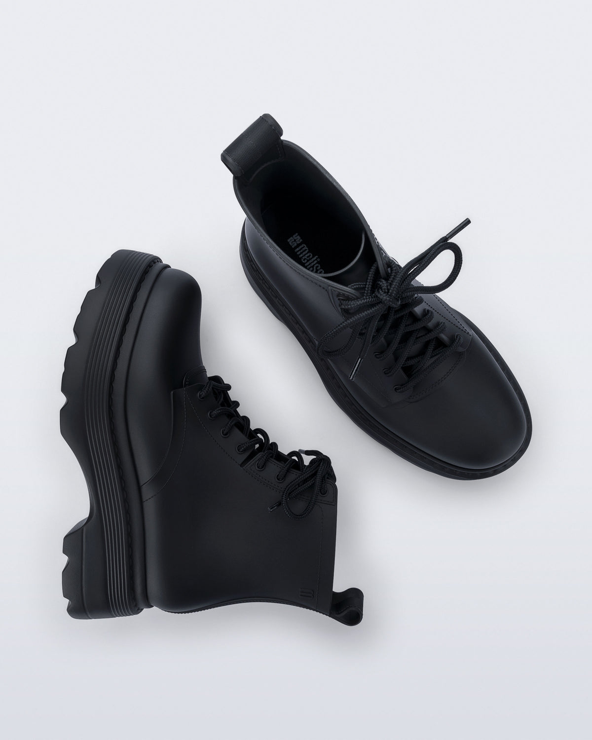 Top and side view of a pair of matte black Coturno Soft Platform boots