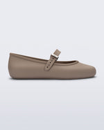 Side view of a dark beige Soft Ballerina flat with top buckle strap