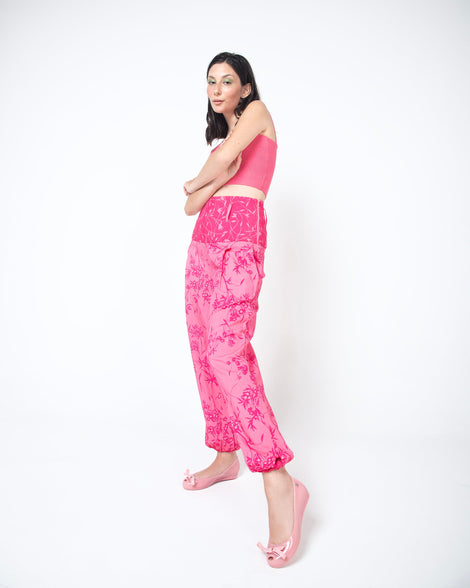 Model in a pink outfit wearing a pair of pink Ultragirl Bow flats