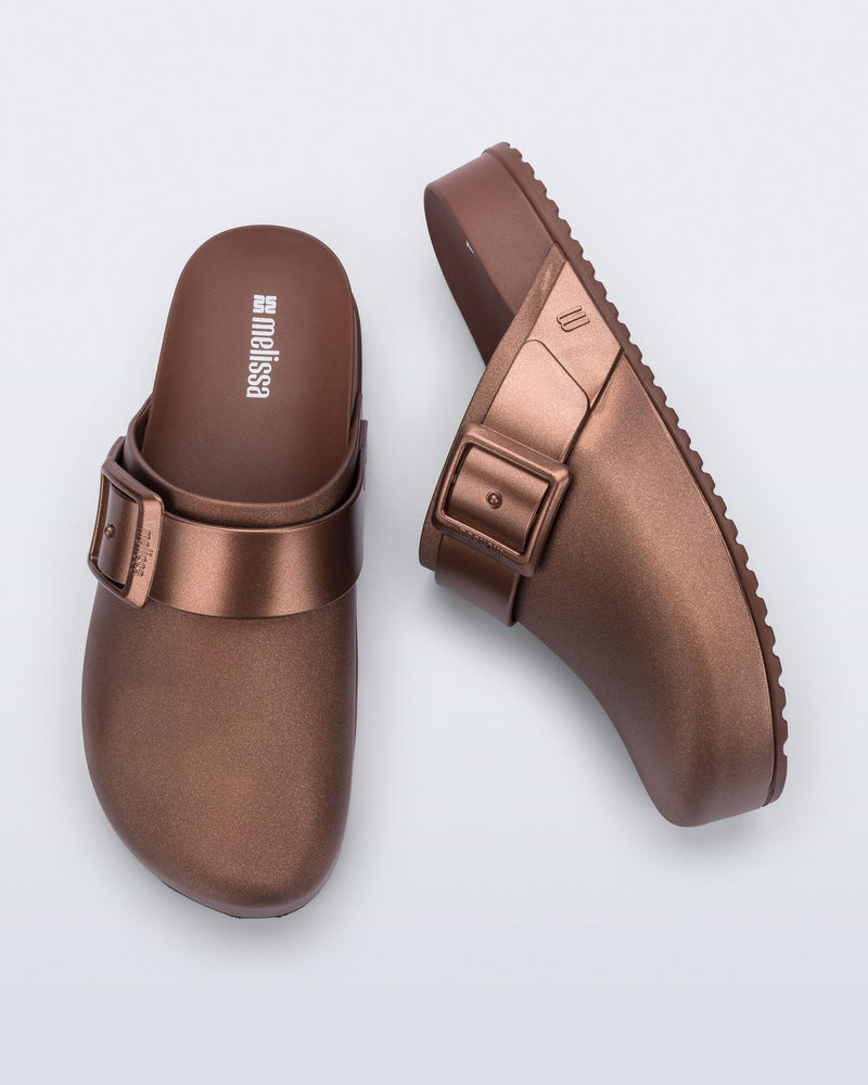 Side and top view of a pair of copper Cozy Clog with buckle decoration