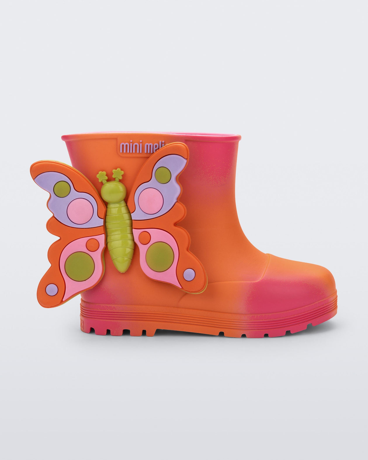 Side view of an orange with pink splotches Welly Wonderland baby boot with orange/green butterfly on side