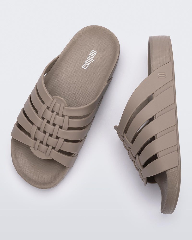 Top and side view of a pair of beige Possession Slide