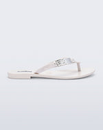 Side view of a white Harmonic M Chic flip flop