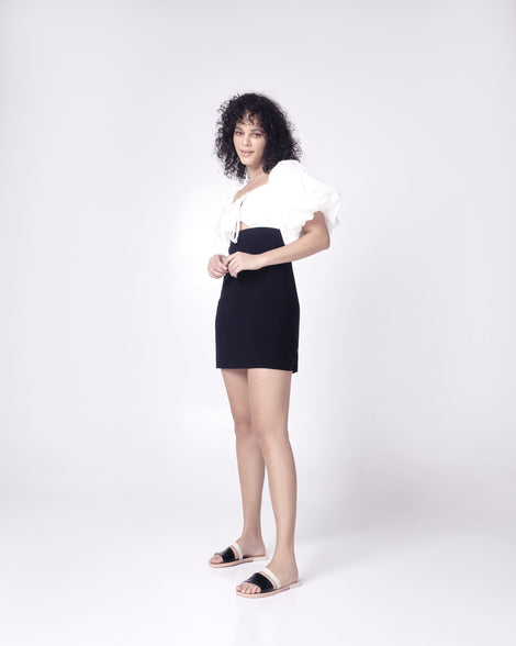 Model in a black and white dress wearing a pair of black and beige Ivy women's slide