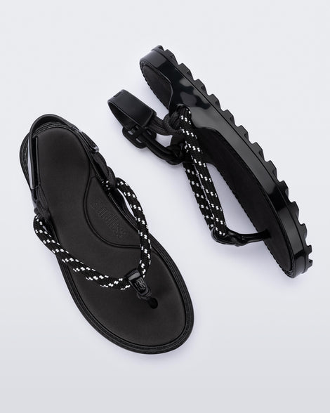 Top and side view of a pair of black Bond sandals with textile strap and black toe piece