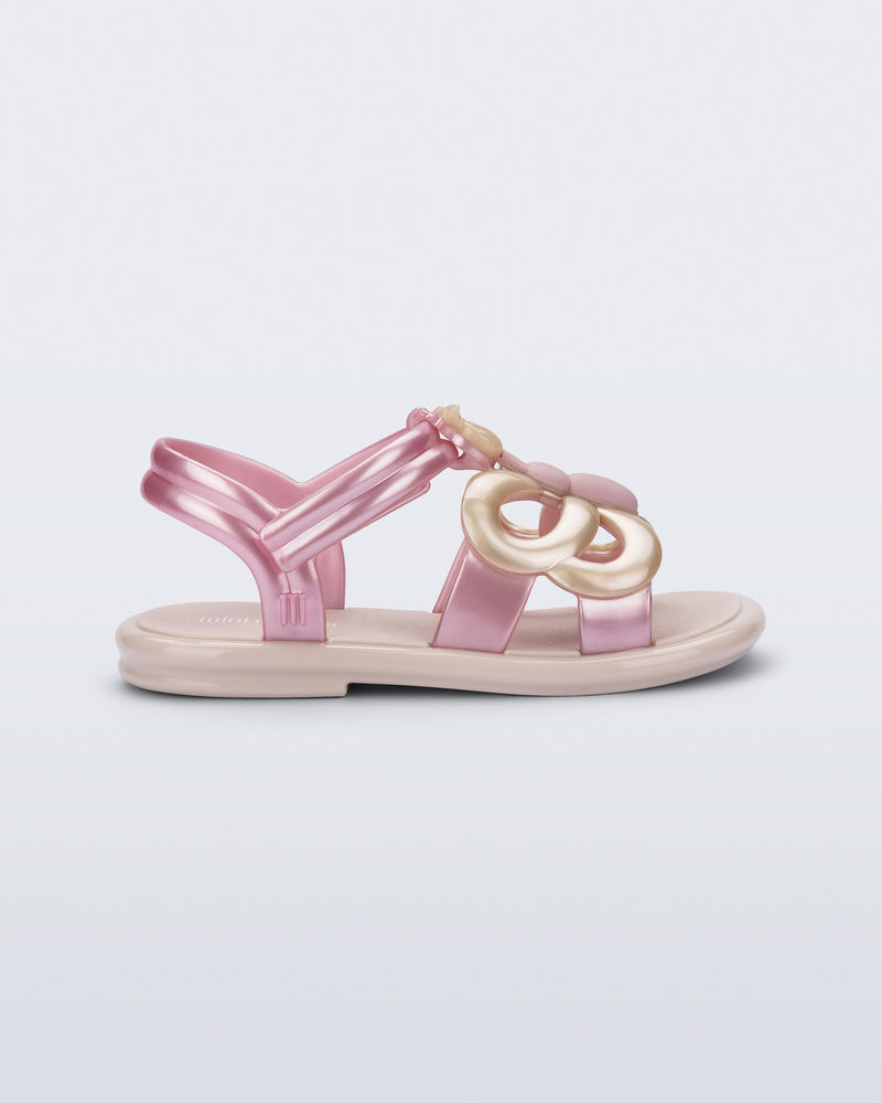 Side view of a pink strap, beige sole Hip Butterfly baby sandal