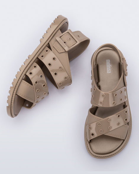 Side and top view of a pair of beige Lock sandals with back strap
