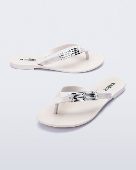 Side and angled view of a pair of white Harmonic M Chic