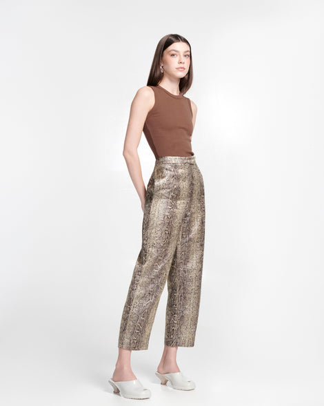 Model in snake print pants and brown tank top wearing a pair of light beige Gaia kitten heels with peep toe