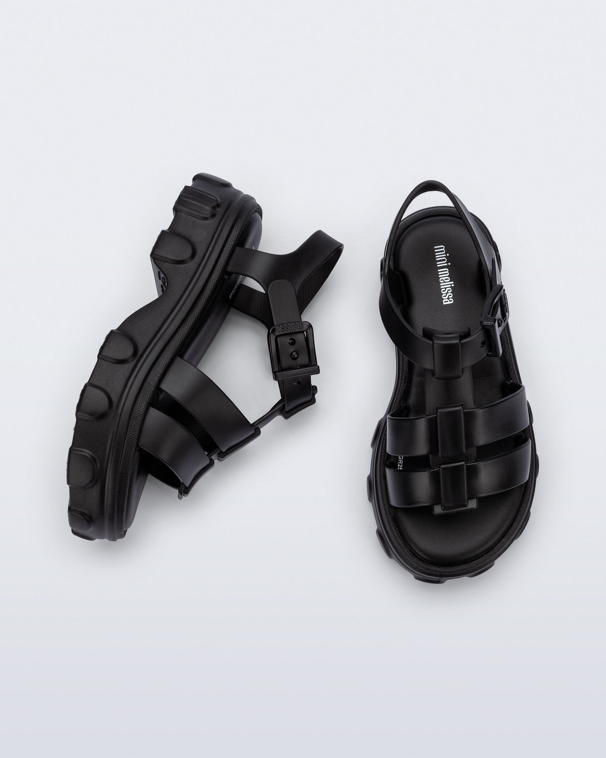 Top and side view of a pair of black Ella kids sandals