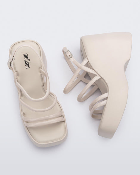Side and top view of a pair of white Jessie platform wedge sandals with side buckle ankle strap