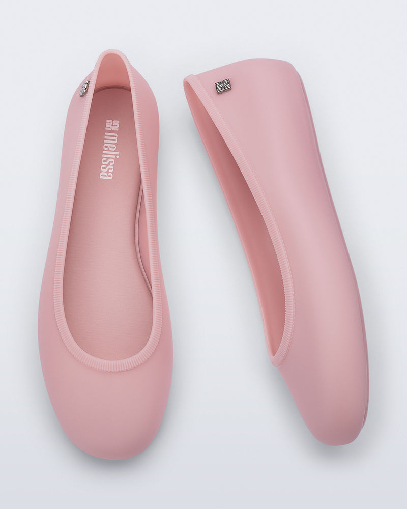 Top and side view of a pair of pink Soft Ballerina Essential flats