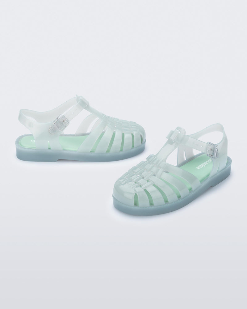 Side and angled view of a pair of light green kids Possession sandals.