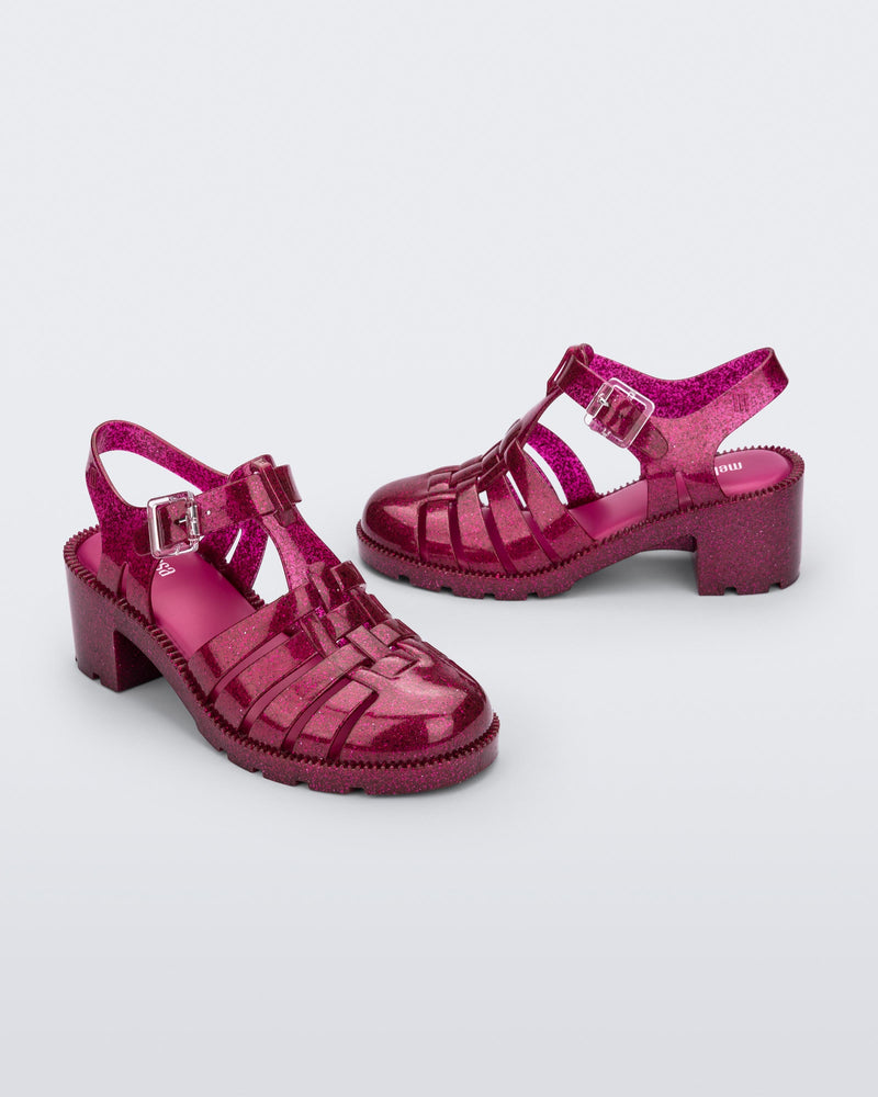 Side and angled view of a pair of glitter pink Possession Heel sandals