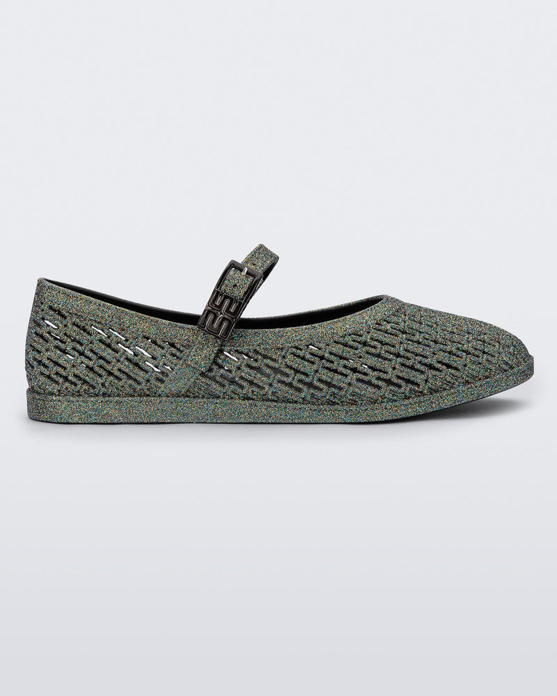 Side view of a dark silver glitter Harper flat with strap