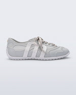 Side view of a grey Motion sneaker with white colored sole and M monogram