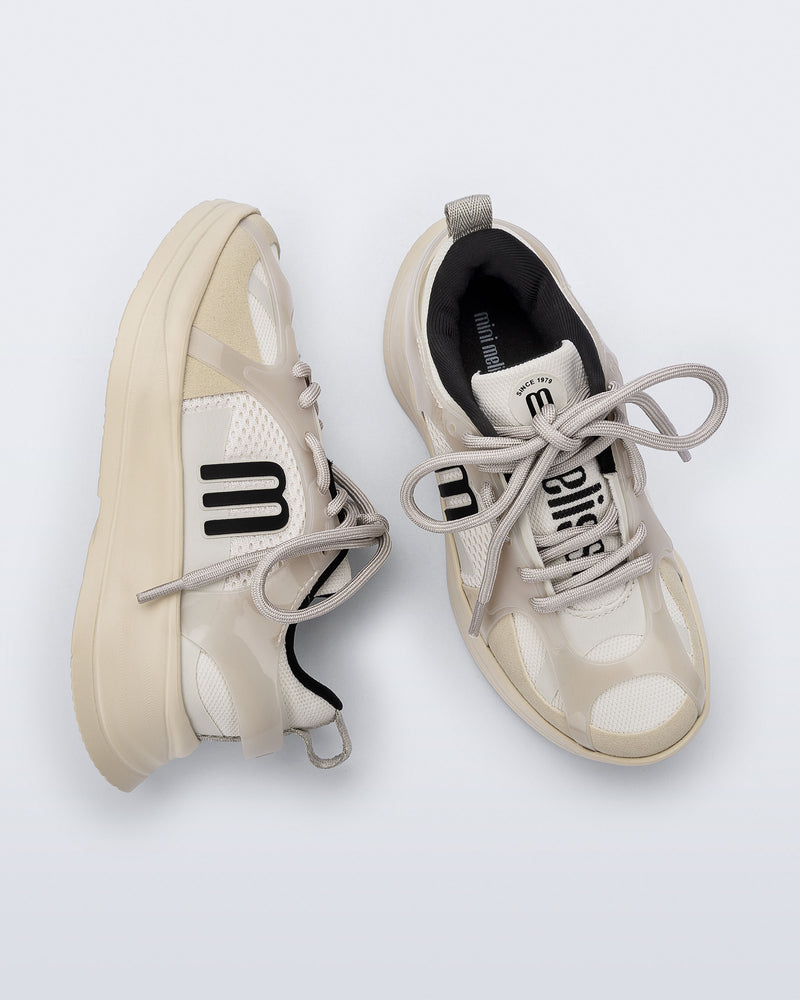Side and top view of a pair of off white X Beat kids sneakers with black trim