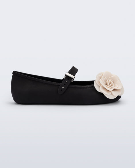 Side view of a black Soft Ballerina Petals flat with beige flowers