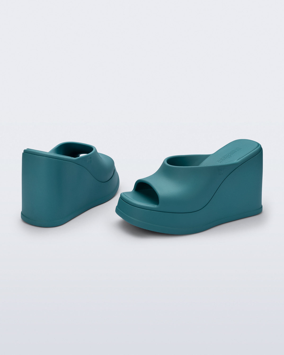 Back and angled view of a pair of blue/green Free Slip platform wedge heels