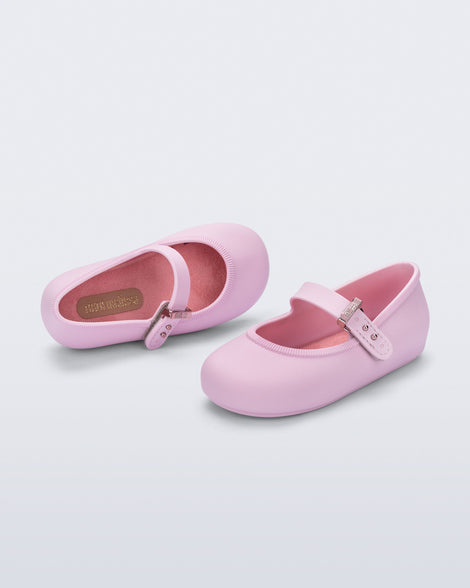 Top and side angled view of a pair of pink Soft Ballerina baby flat with Velcro strap
