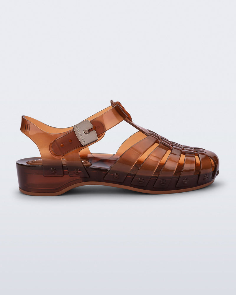 Side view of a clear brown Possession Pescura + Scholl fisherman sandal with white bottom sole