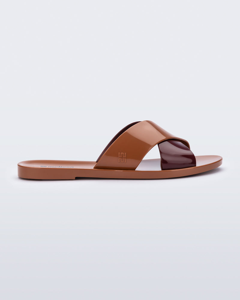 Side view of a brown Essential Cross Slide sandal