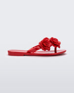 Side view of a red Harmonic Springtime kids flip flop with three red flowers.