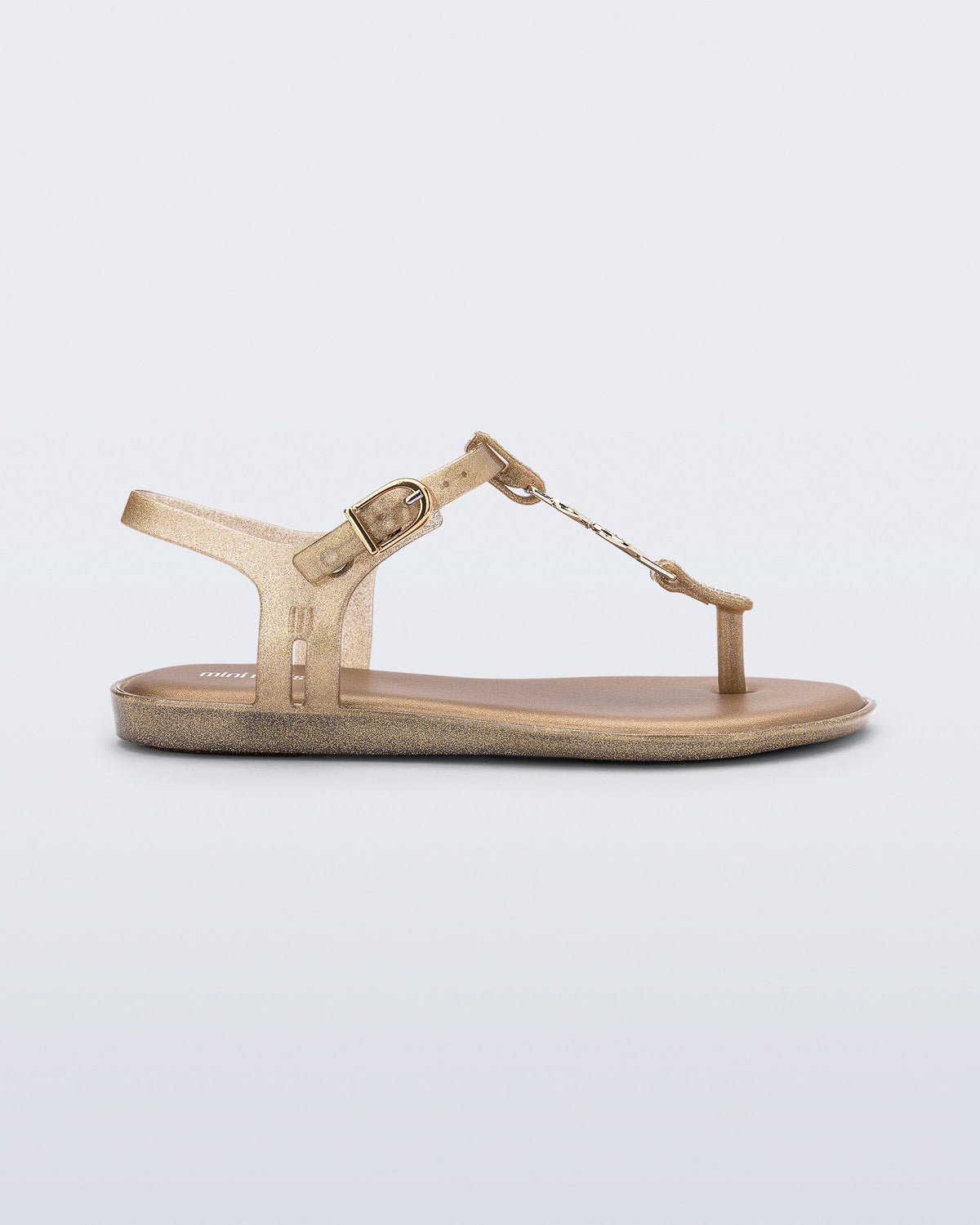 Side view of a gold glitter Solar kids sandal