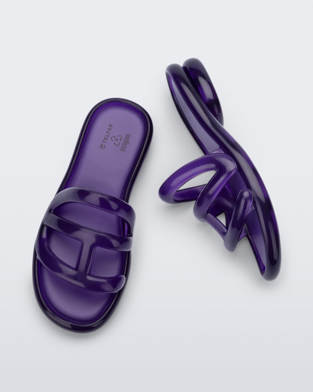Top and side view of a pair of purple Jelly Slide x Telfar.