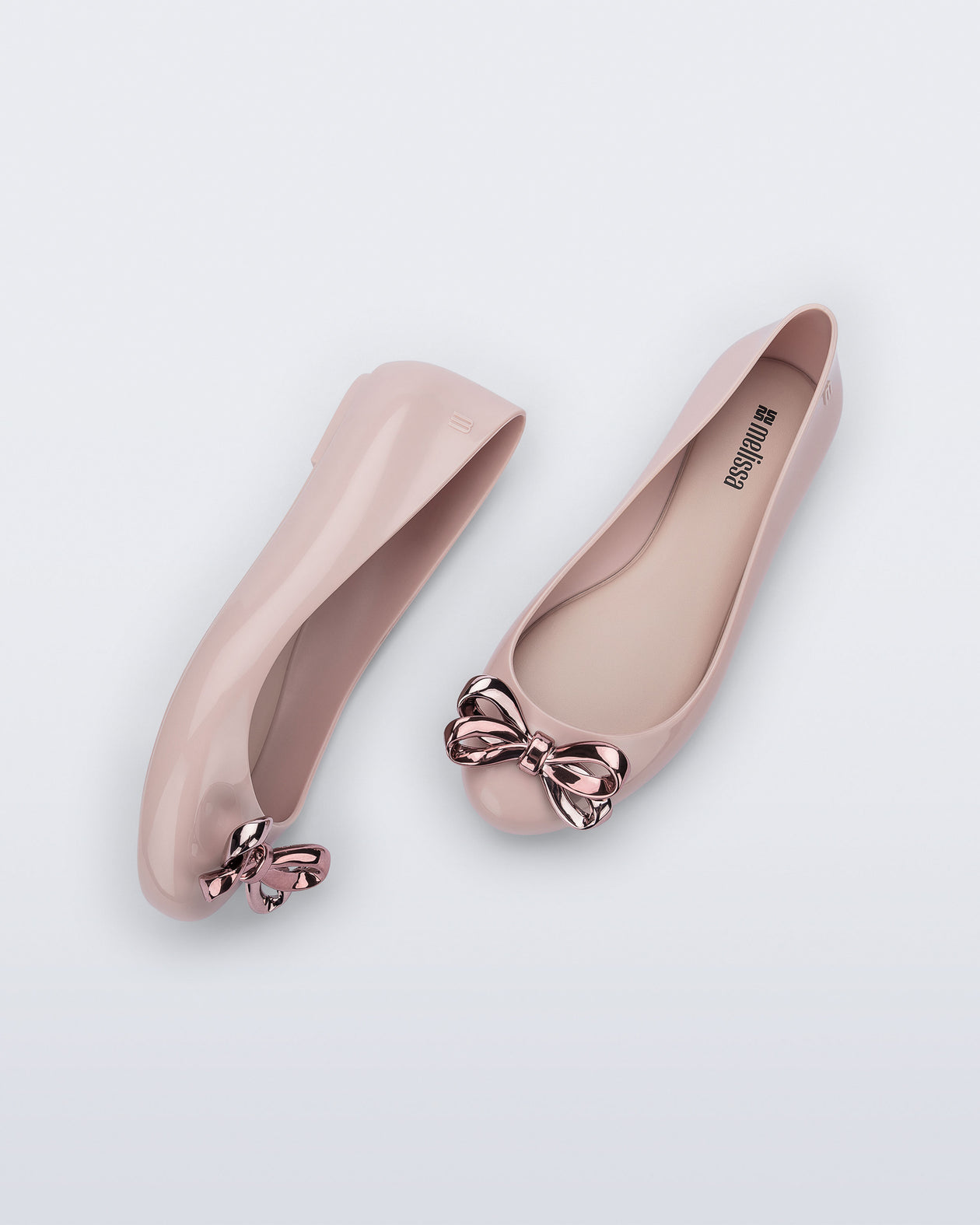 Side and top view of a pair of pink Sweet Love Glam ballerina flats with pink chrome bow