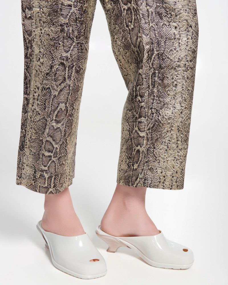 Model's legs in snake skin pants wearing a pair of light beige Gaia kitten heels with peep toe