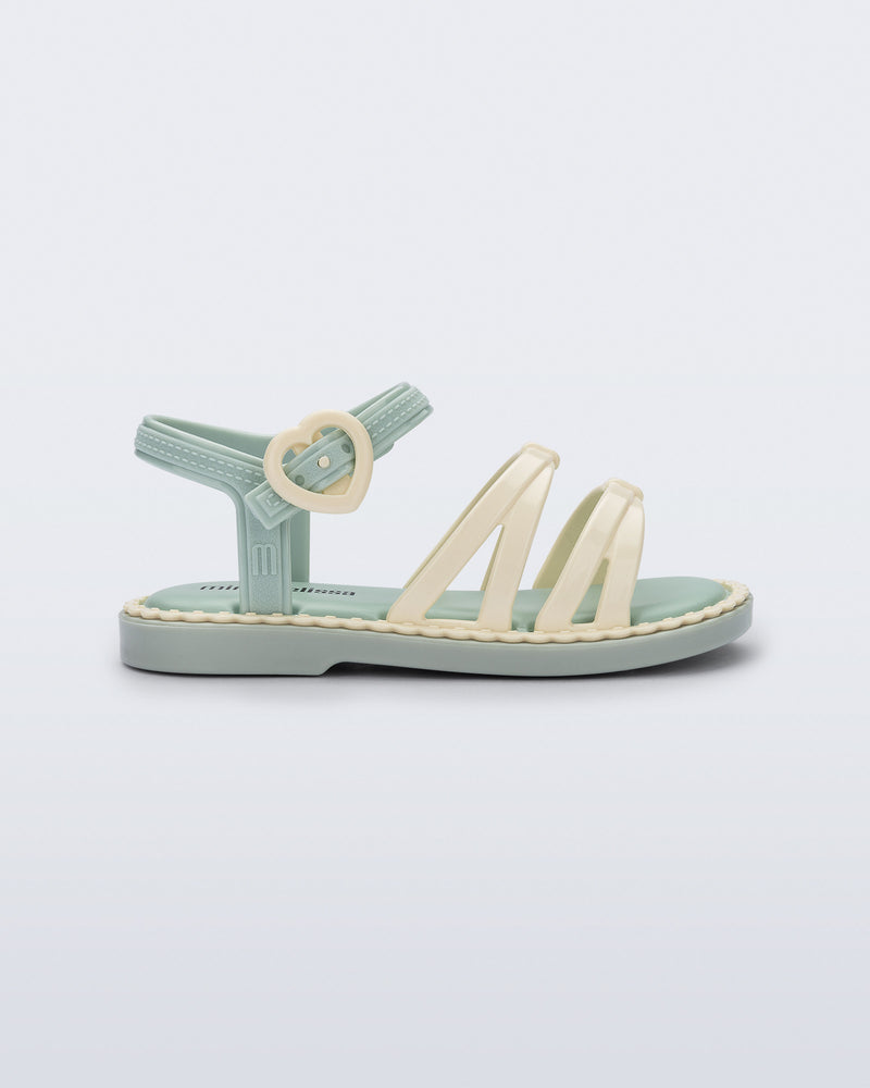 Side view of a green Aurora baby sandal with beige trim, straps and buckle