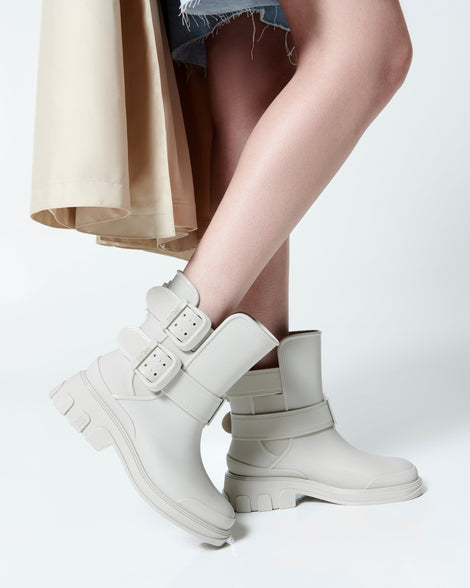 Model's legs in a pair of beige Bang Boots with two side buckles