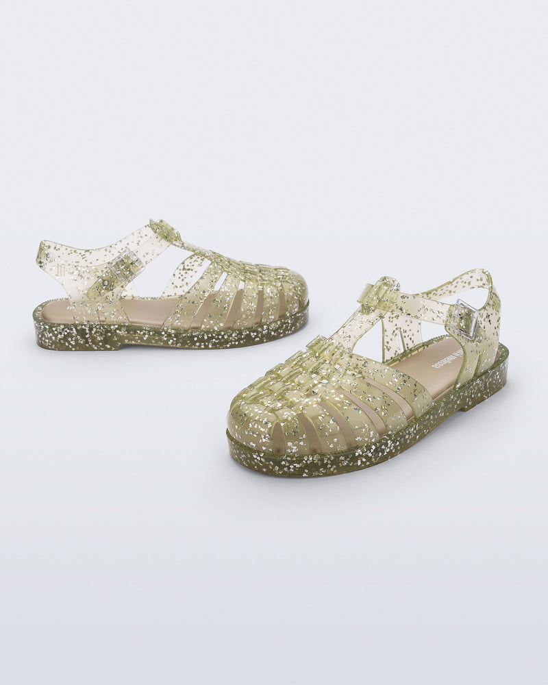 Side and angled view of a pair of yellow Possession kids sandals with heart glitter