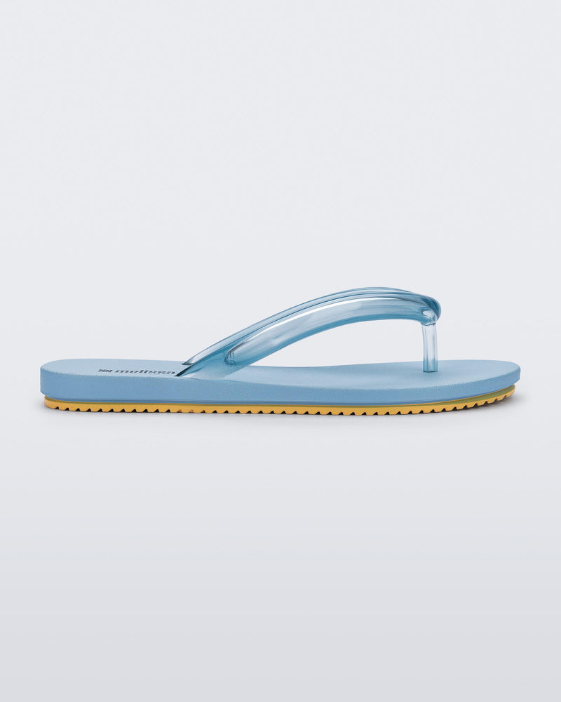 Side view of a blue Flip Flop Airflow sandal with a clear blue strap and yellow bottom