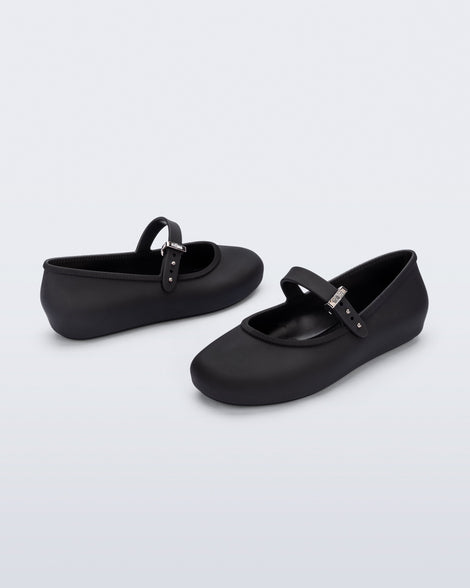 Back and side angled view of a pair of black Soft Ballerina kids flat with strap