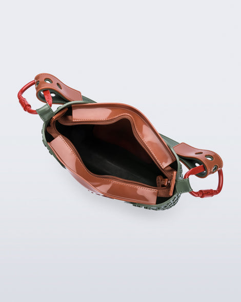 Top view of a dark green Nina Bag + Alexandre Pavao shoulder bag with brown accents