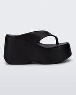 Side view of a black Free Thong Wedge Platform heel