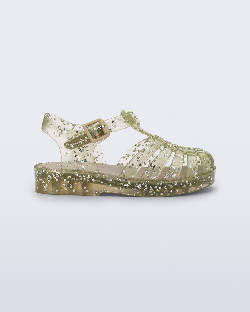 Side view of a yellow Possession Elements baby sandal with glitter hearts
