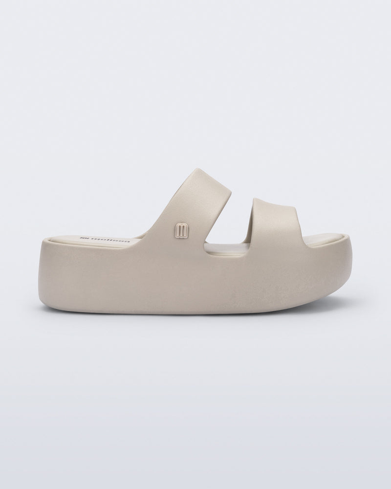 Side view of a beige Free Line Platform slide