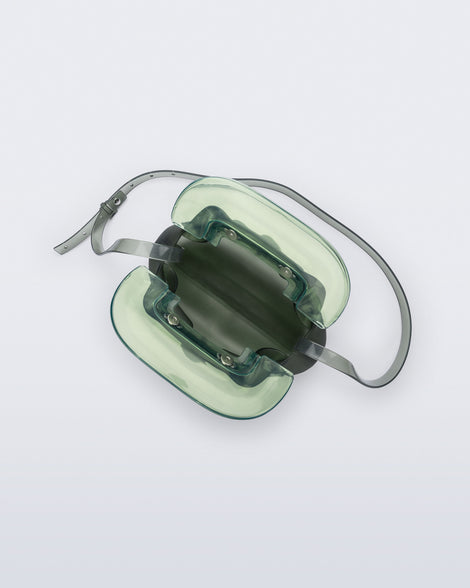Top view of a small green bag with clear green clutch and long strap