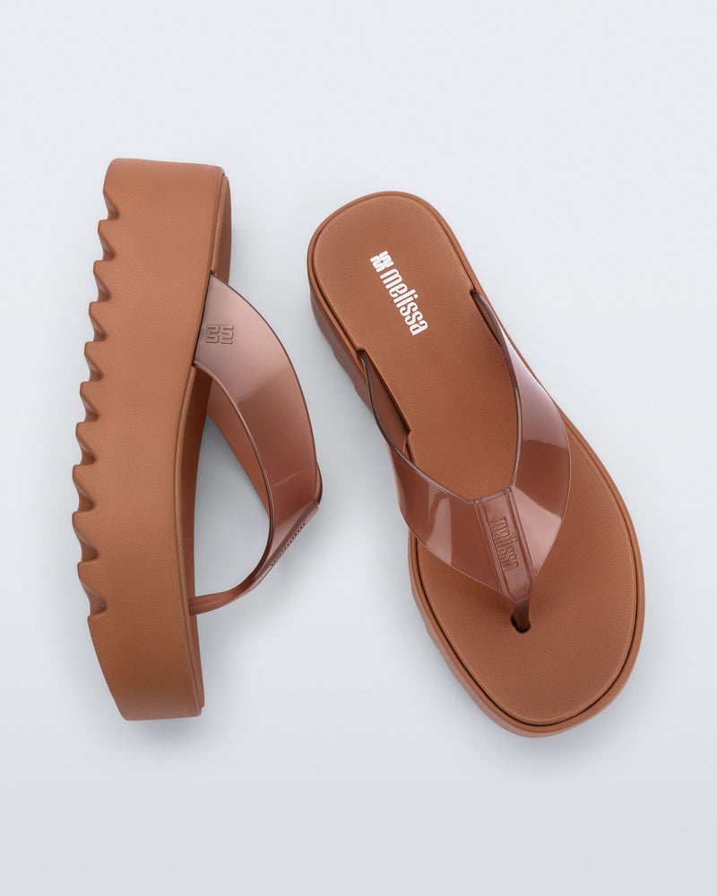 Angled and top view of a pair of brown Thong Platform flip flops